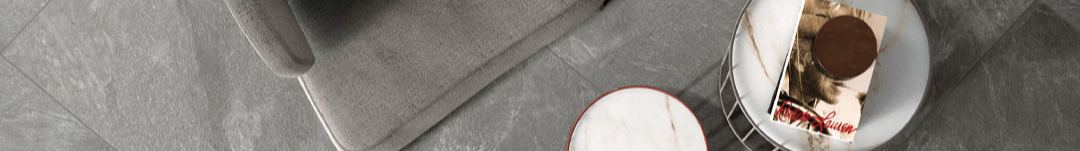 Close-up of a marble-patterned surface with a small round object and a cylindrical container.