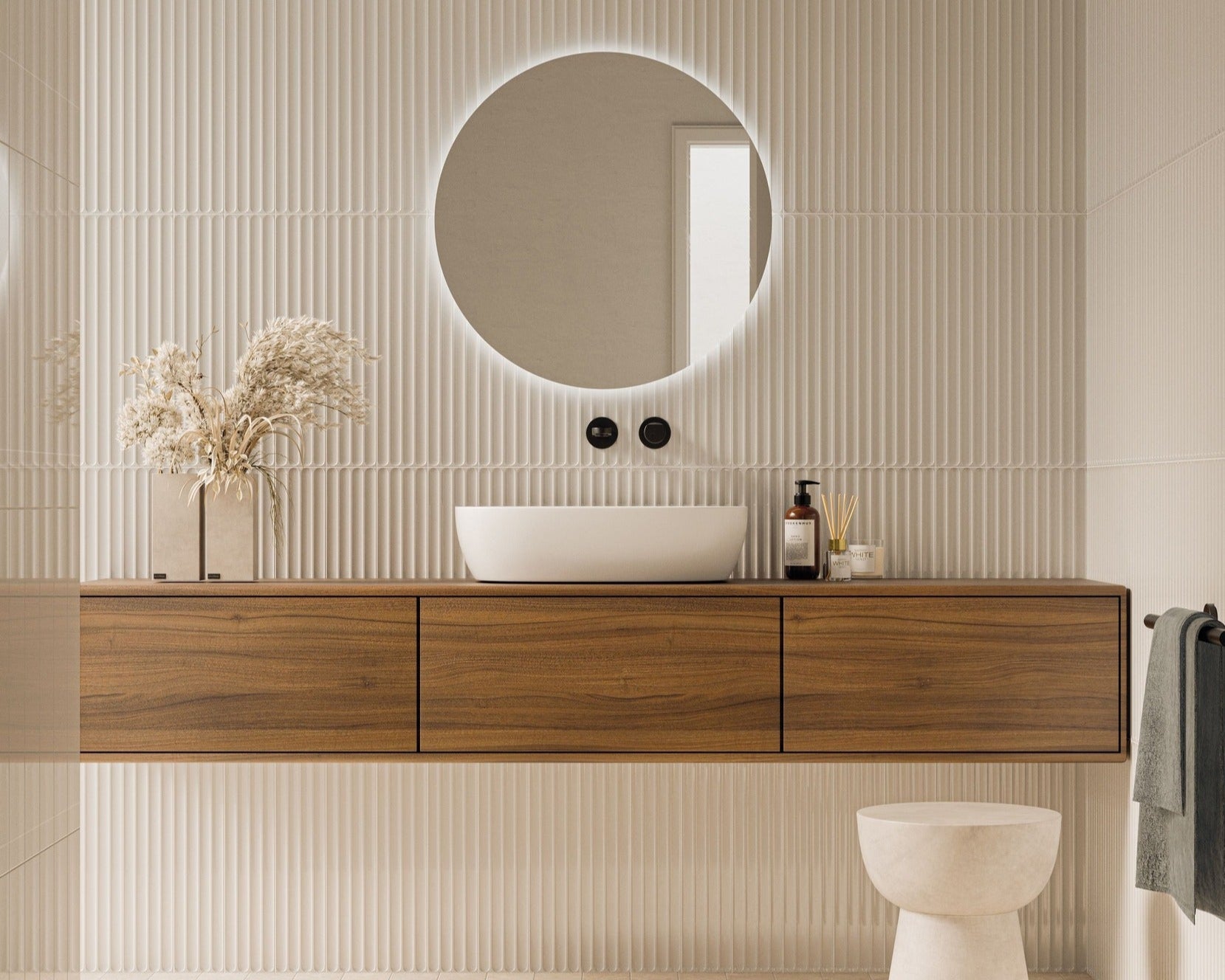 Modern bathroom with wooden vanity, round mirror, and white toilet.