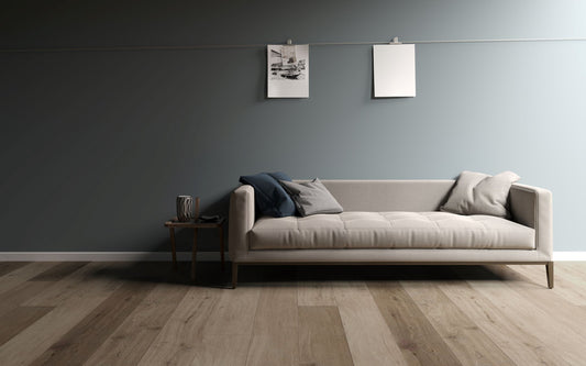 Modern living room with a long sofa against a gray wall, Hybri flooring